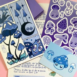 Illustration de plusieurs cartes artistiques bleues représentant des créatures marines, une sirène et des motifs océaniques, disposées sur un fond vert.