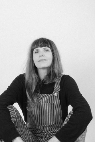 Christine Mercadier portant la salopette rayée de la marque.