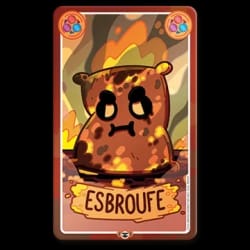Carte de jeu représentant un sac de pirate avec un cache-œil, un chapeau à tête de mort et une épée, sur fond de bateau, avec le mot ESBROUFE écrit sur une plaque en bois en bas.