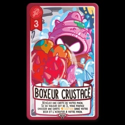Carte de jeu "Boxeur crustacé" avec une valeur d'attaque de 3. L'illustration montre une créature rose ressemblant à un coquillage. Texte : "Révélez une carte de votre main. Si sa valeur est de 3...".